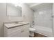 Bathroom showcasing a granite countertop, white cabinets, and a white tiled shower and tub combo at 5415 Tracey Dr, Stone Mountain, GA 30088
