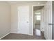 Bedroom featuring neutral carpet and an open door to a room with hardwood floors at 5415 Tracey Dr, Stone Mountain, GA 30088