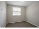 Bedroom with a window letting in natural light and neutral gray carpet at 5415 Tracey Dr, Stone Mountain, GA 30088
