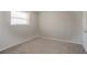 Bedroom features neutral paint, carpet, one window providing natural light, and a white door to closet at 5415 Tracey Dr, Stone Mountain, GA 30088