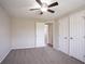 Bedroom featuring neutral carpet, a ceiling fan, and a view into the hallway at 5415 Tracey Dr, Stone Mountain, GA 30088