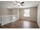 Bonus room featuring hardwood floors, white railing and a window with natural light at 5415 Tracey Dr, Stone Mountain, GA 30088