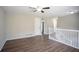 Bonus room with hard wood floors, white railing, and a view of the entry and kitchen area at 5415 Tracey Dr, Stone Mountain, GA 30088