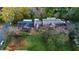 Aerial view of the brick apartment building surrounded by trees, a lawn, and neighborhood streets at 208 Doane St, Atlanta, GA 30315