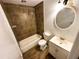 Bathroom featuring a tub/shower combo, sink, and round mirror at 208 Doane St, Atlanta, GA 30315