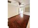 Bright bedroom with glossy hardwood floors, ceiling fan, and door leading outside at 208 Doane St, Atlanta, GA 30315