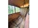 Covered patio with wood floors and brick accent walls at 208 Doane St, Atlanta, GA 30315