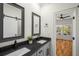 Bathroom with double sinks, dark countertops, and a view to an adjacent bedroom at 431 Clifton Ne Rd, Atlanta, GA 30307