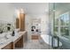 Modern bathroom featuring double sinks, marble countertops, soaking tub, and glass enclosed shower at 431 Clifton Ne Rd, Atlanta, GA 30307