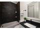 Modern bathroom with a black subway tile accent wall, sleek vanity, and a well-lit mirror creating a stylish space at 431 Clifton Ne Rd, Atlanta, GA 30307