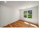 Cozy bedroom with a window overlooking the yard and hardwood floors with bright white walls and trim at 431 Clifton Ne Rd, Atlanta, GA 30307