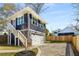 Exterior elevation of home showing stairway leading to additional living space above the garage at 431 Clifton Ne Rd, Atlanta, GA 30307