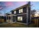 Charming two-story home featuring dark siding, white trim, and a welcoming front porch with manicured lawn at 431 Clifton Ne Rd, Atlanta, GA 30307