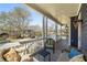 Cozy front porch with wicker seating, side table, and a stylish outdoor rug, perfect for relaxing and enjoying the neighborhood views at 431 Clifton Ne Rd, Atlanta, GA 30307