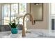 Kitchen featuring a modern gold faucet, stone countertops, and sleek cabinetry, combining elegance and functionality at 431 Clifton Ne Rd, Atlanta, GA 30307