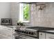 Modern kitchen with stainless steel oven, cooktop, pot filler, and subway tile backsplash, designed for cooking enthusiasts at 431 Clifton Ne Rd, Atlanta, GA 30307