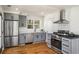 Well-lit kitchen with gray cabinets, stainless steel appliances, hardwood floors and marble counters at 431 Clifton Ne Rd, Atlanta, GA 30307