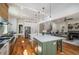 Open concept kitchen with island, stainless appliances, hardwood floors, and view to the living room at 431 Clifton Ne Rd, Atlanta, GA 30307