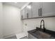 Laundry room featuring grey cabinets and sink at 431 Clifton Ne Rd, Atlanta, GA 30307