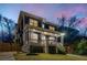 Stylish two-story home with a covered front porch illuminated by exterior lighting at 431 Clifton Ne Rd, Atlanta, GA 30307