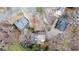 An aerial view of several homes featuring various roof designs, surrounded by trees and private driveways at 8498 Colony Club Dr, Alpharetta, GA 30022
