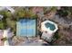 Aerial view of two tennis courts and a covered pool surrounded by trees in this community at 8498 Colony Club Dr, Alpharetta, GA 30022