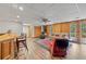 Basement Gathering room features a bar, wood paneling, and walk-out access to outdoor deck at 8498 Colony Club Dr, Alpharetta, GA 30022