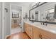 Bright bathroom with a double vanity, wood floors, neutral tile and modern fixtures at 8498 Colony Club Dr, Alpharetta, GA 30022