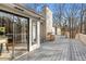 View of a large wooden deck with a grill, heater, and exterior access to the home at 8498 Colony Club Dr, Alpharetta, GA 30022