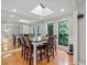 Bright dining room with a skylight, multiple windows, and hardwood floors at 8498 Colony Club Dr, Alpharetta, GA 30022