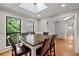 Dining room with hardwood floors and views of the surrounding trees at 8498 Colony Club Dr, Alpharetta, GA 30022