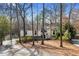 Charming home nestled among the trees with a stone accent and long driveway at 8498 Colony Club Dr, Alpharetta, GA 30022