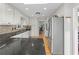 Modern kitchen featuring white cabinets, stainless appliances, and granite countertops at 8498 Colony Club Dr, Alpharetta, GA 30022