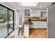 Kitchen with access to deck, white cabinets, wine racks, and granite countertop at 8498 Colony Club Dr, Alpharetta, GA 30022