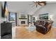 Spacious living room featuring hardwood floors, a fireplace, and plenty of natural light at 8498 Colony Club Dr, Alpharetta, GA 30022