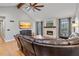 Living room with a stone fireplace, hardwood floors, a ceiling fan, and a flat-screen TV at 8498 Colony Club Dr, Alpharetta, GA 30022