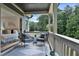 Inviting balcony with seating overlooks lush trees, while entering into the bright primary bedroom at 2175 James Aly, Atlanta, GA 30345