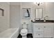 Neutral toned bathroom with bathtub and shower combination, dark countertops and custom vanity at 2175 James Aly, Atlanta, GA 30345
