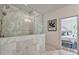 Luxurious bathroom showcasing a frameless glass shower and a glimpse into the well-lit bedroom at 2175 James Aly, Atlanta, GA 30345