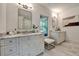 Bright bathroom featuring double vanity with marble countertop and contemporary mirrors and lighting at 2175 James Aly, Atlanta, GA 30345