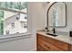Modern bathroom showcasing a sleek vanity with marble countertop, dark fixtures and natural light at 2175 James Aly, Atlanta, GA 30345