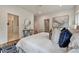 Bright bedroom features a ceiling fan, hardwood floors, a patterned rug, and a walk-in closet at 2175 James Aly, Atlanta, GA 30345