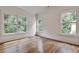 Bright bedroom with hardwood floors and three windows, providing natural light at 2175 James Aly, Atlanta, GA 30345
