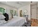 Bright bedroom features a ceiling fan, hardwood floors, a patterned rug, and an ensuite bathroom at 2175 James Aly, Atlanta, GA 30345