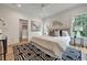 Bright bedroom features a ceiling fan, hardwood floors, a patterned rug, and a walk-in closet at 2175 James Aly, Atlanta, GA 30345