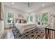 Bright bedroom features a ceiling fan, hardwood floors, a black and white rug, and doors to a balcony at 2175 James Aly, Atlanta, GA 30345