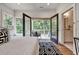 Bright bedroom has a private balcony, hardwood floors, a stylish rug, and an ensuite bathroom at 2175 James Aly, Atlanta, GA 30345