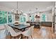 Open-concept dining area showcasing a modern chandelier, large windows, and seamless flow into the kitchen at 2175 James Aly, Atlanta, GA 30345