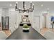Open dining room with modern chandelier, stainless steel appliances, and light wood floors throughout at 2175 James Aly, Atlanta, GA 30345