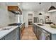 Gourmet kitchen with stainless steel appliances, large island with sink, and views of the open concept living area at 2175 James Aly, Atlanta, GA 30345